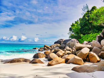 Rocks on beach against sky