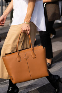 Midsection of woman holding bag