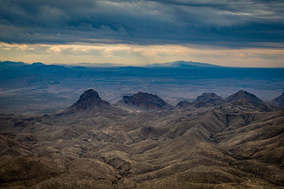 Scenic view of rocky mountains against cloudy sky