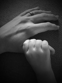 Close-up of the hands of a child and his mother