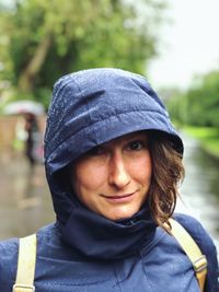 Portrait of smiling woman wearing raincoat