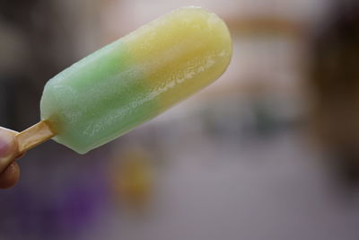 Close-up of hand holding ice cream