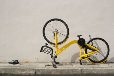 Bicycle parked on wall