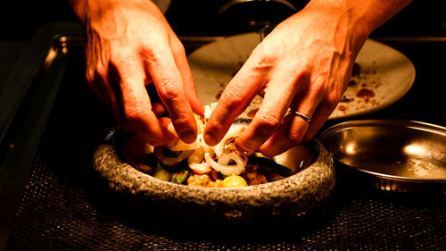 Midsection of man preparing food