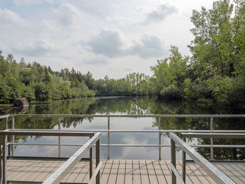 Scenic view of lake in forest against sky