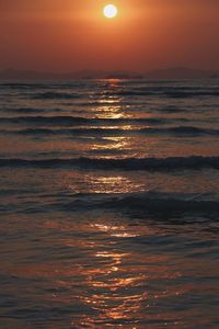 Scenic view of sea against orange sky