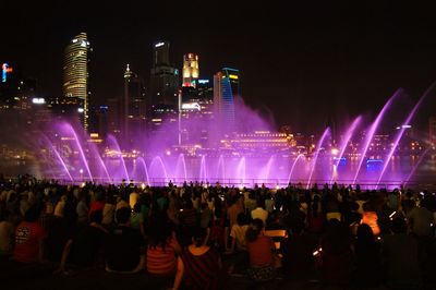 People enjoying fountain at night