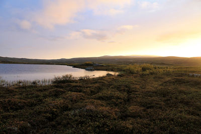 Scenic view of lake against sky during sunset