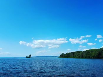 Scenic view of sea against blue sky