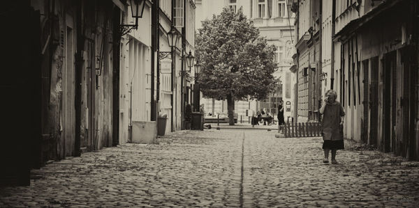 Woman walking on footpath