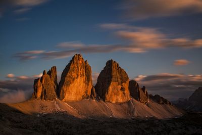 Panoramic view of rock formations against sky during sunset