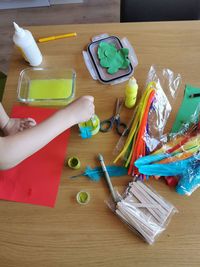 High angle view of hand holding paper, hobby första at home