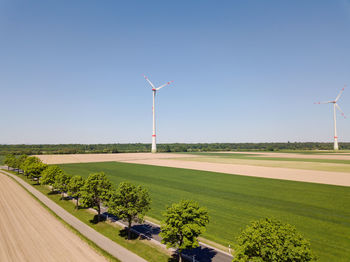 Windmill on field against clear sky