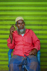 Portrait of smiling man sitting outdoors