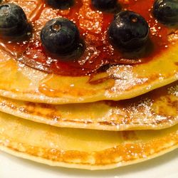 Close-up of pancakes with blueberries and honey