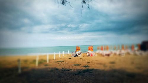 People on beach against sky