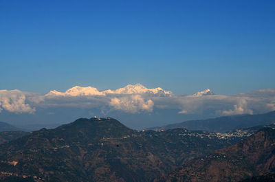 View of mountain range against blue sky