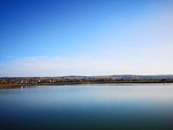 Scenic view of sea against blue sky