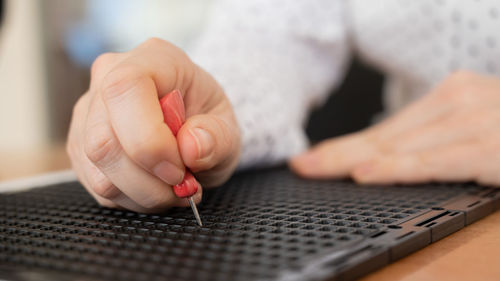 Midsection of man working on table