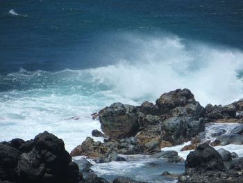 Waves breaking on rocks at shore