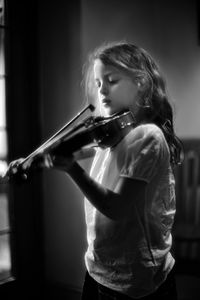 Midsection of girl playing violin