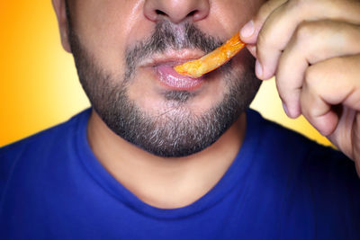 Close-up of young man eating apple