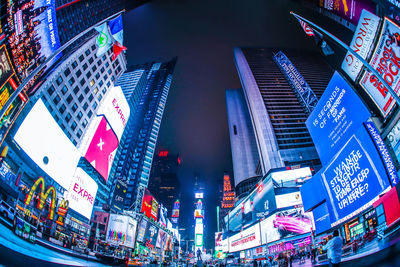 Low angle view of illuminated modern buildings in city at night