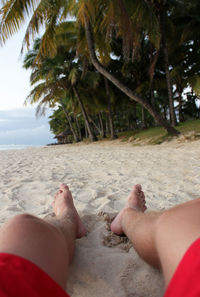 Low section of people relaxing on beach