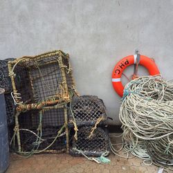 Life belt and rope stack against wall at padstow