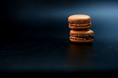 Close-up of cookies on table against black background