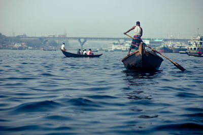 People kayaking in sea