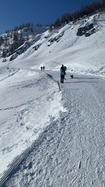 People skiing on snow covered mountain