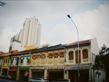 Low angle view of building against cloudy sky