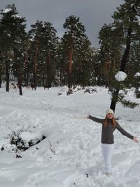 Full length of man standing on snow covered field