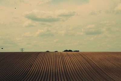 Scenic view of landscape against cloudy sky