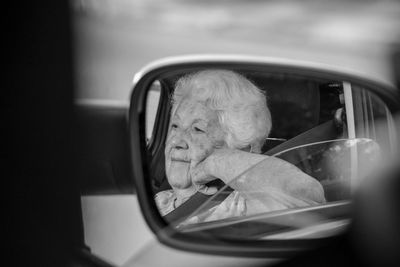 Portrait of woman in car window