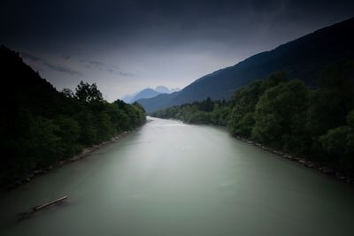 River amidst trees against sky