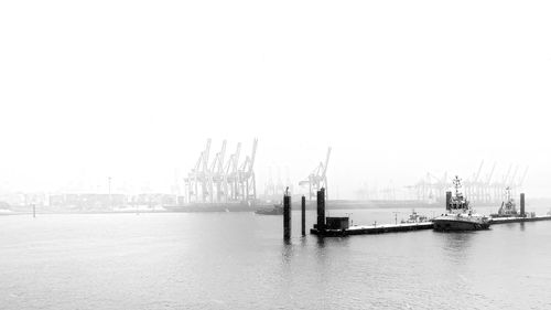 Ship at harbor against clear sky