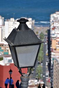 Close-up of lantern against buildings