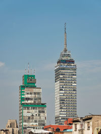 Low angle view of buildings against blue sky