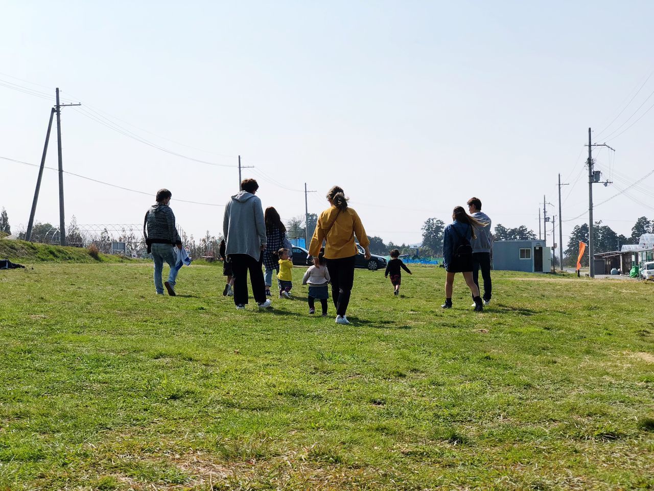 PEOPLE ON FIELD AGAINST SKY