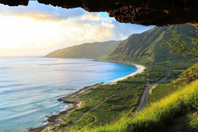 Scenic view of sea and mountains against sky