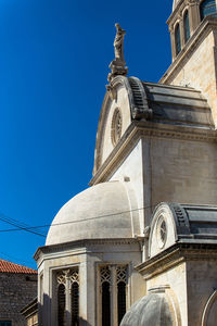 Low angle view of building against clear blue sky