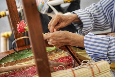 Midsection of man preparing food