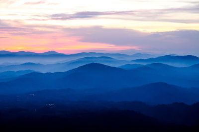 Scenic view of silhouette mountains against sky during sunset