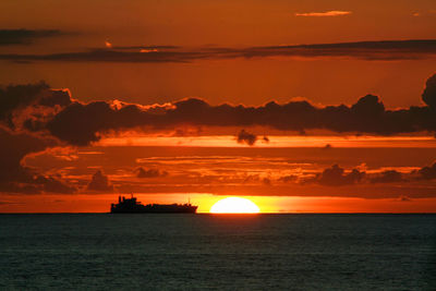 Scenic view of sea against romantic sky at sunset