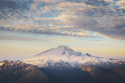 Scenic view of snowcapped mountains against sky during sunset