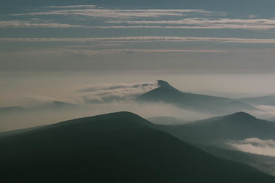 Scenic view of mountain against cloudy sky