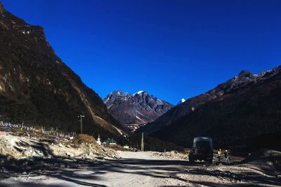 Scenic view of snowcapped mountains against clear blue sky