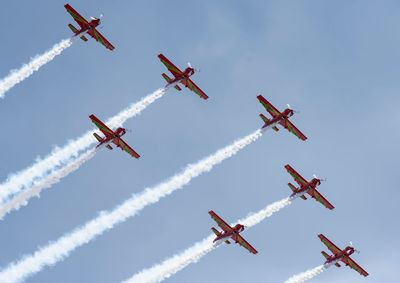 Low angle view of airshow against clear sky